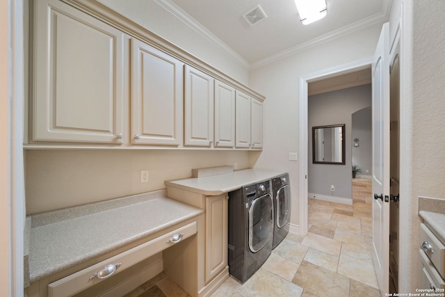 washroom with visible vents, baseboards, washer and dryer, cabinet space, and crown molding