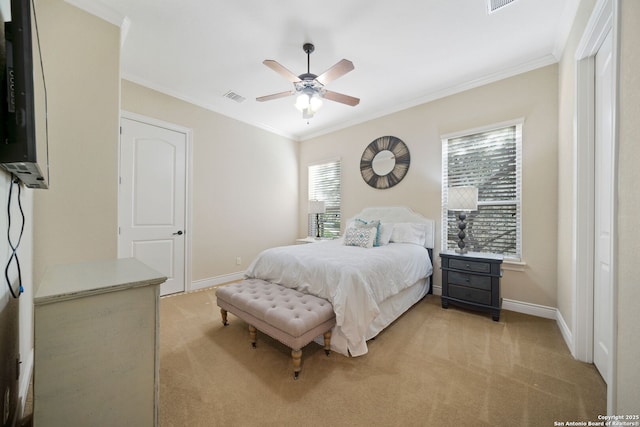 bedroom featuring light colored carpet, crown molding, visible vents, and baseboards