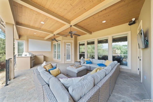 view of patio / terrace with an outdoor kitchen, an outdoor living space, and a ceiling fan