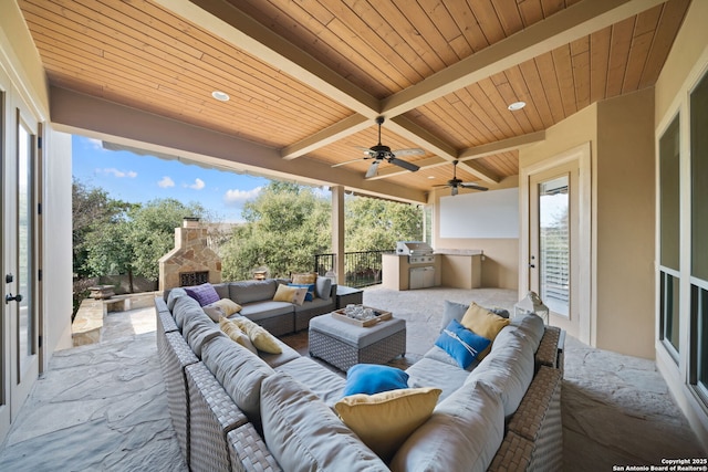 view of patio with an outdoor living space with a fireplace, grilling area, area for grilling, and a ceiling fan