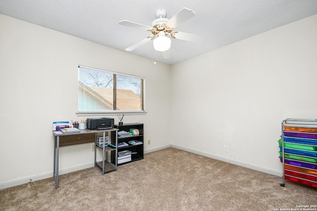 home office with carpet, baseboards, ceiling fan, and a textured ceiling
