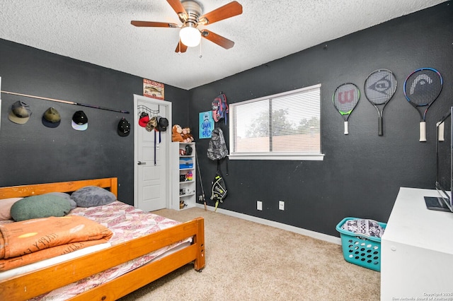 bedroom featuring a ceiling fan, carpet, a textured ceiling, and baseboards