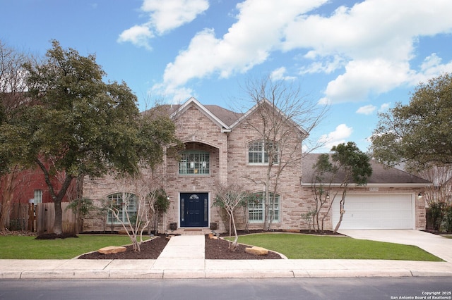 view of front of property featuring a garage, concrete driveway, brick siding, and a front yard