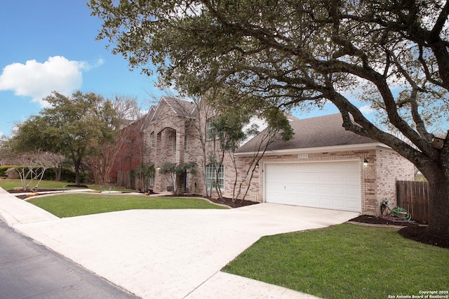 view of front of house featuring a garage, a front yard, brick siding, and driveway