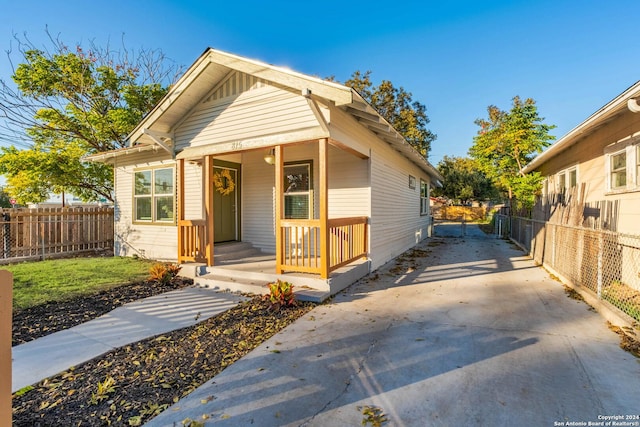 bungalow-style house featuring fence and a porch