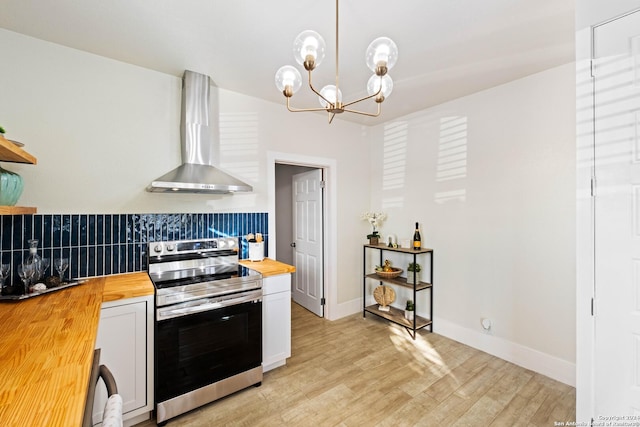 kitchen with decorative backsplash, wall chimney exhaust hood, stainless steel electric range, open shelves, and wooden counters