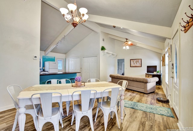 dining area with ceiling fan with notable chandelier, baseboards, beamed ceiling, and wood finished floors