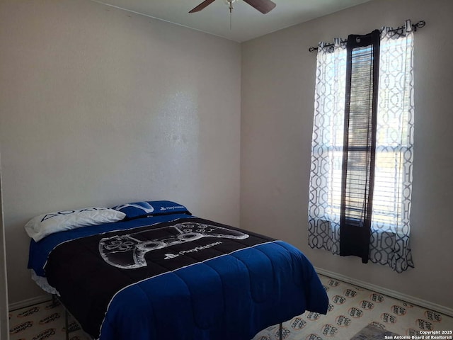 bedroom featuring ceiling fan and baseboards