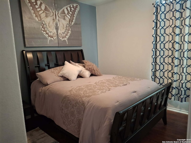 bedroom with wood finished floors