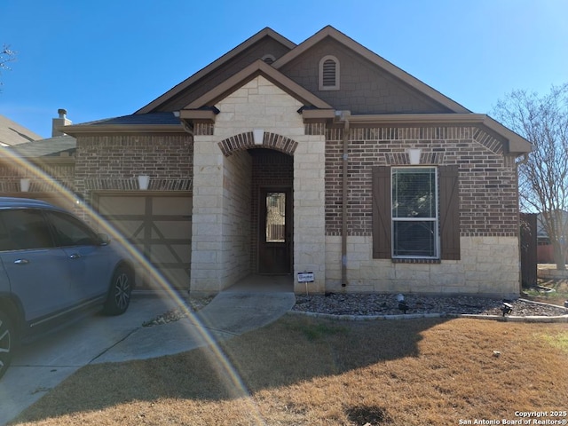 view of front facade featuring stone siding, concrete driveway, brick siding, and an attached garage