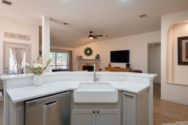 kitchen with a sink, visible vents, open floor plan, and stainless steel dishwasher