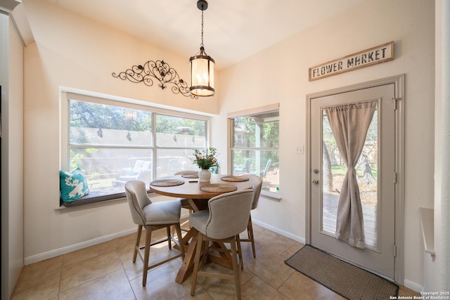 dining room featuring light tile patterned floors, an inviting chandelier, and baseboards