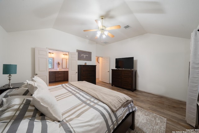 bedroom with lofted ceiling, ceiling fan, wood finished floors, and visible vents