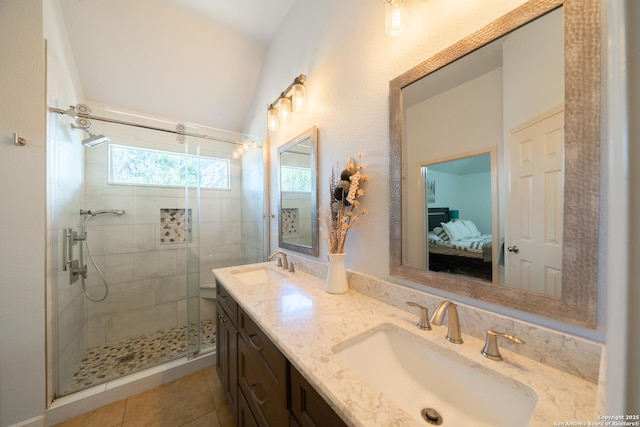 bathroom with double vanity, a shower stall, connected bathroom, and a sink