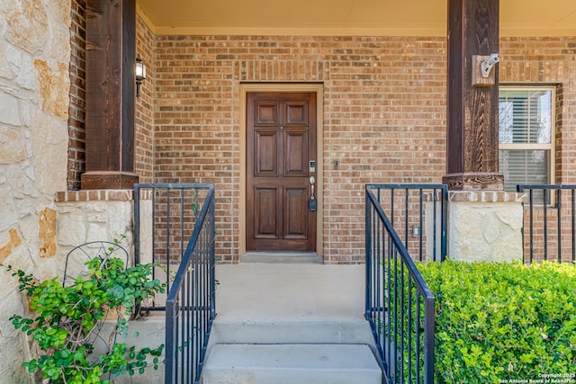 doorway to property featuring brick siding