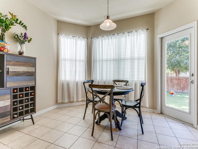 dining area with light tile patterned flooring and baseboards