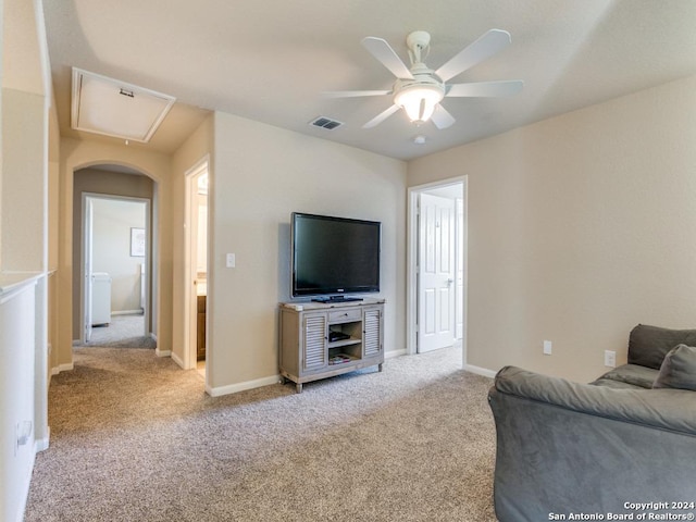 living room featuring visible vents, attic access, light carpet, ceiling fan, and baseboards