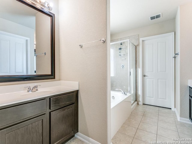 bathroom with visible vents, vanity, a shower stall, and tile patterned floors