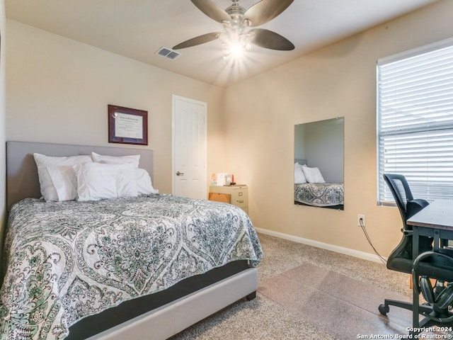 carpeted bedroom with a ceiling fan, visible vents, and baseboards