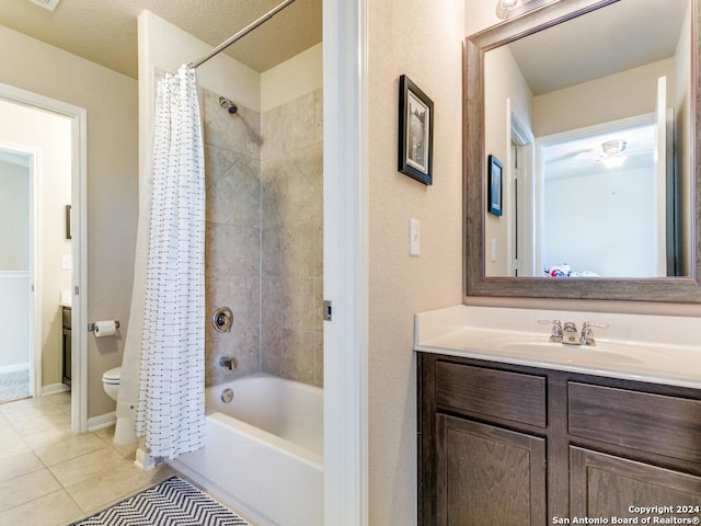 full bath featuring toilet, shower / tub combo, vanity, baseboards, and tile patterned floors