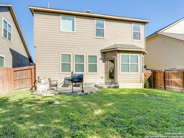 back of property featuring a patio, a lawn, and a fenced backyard