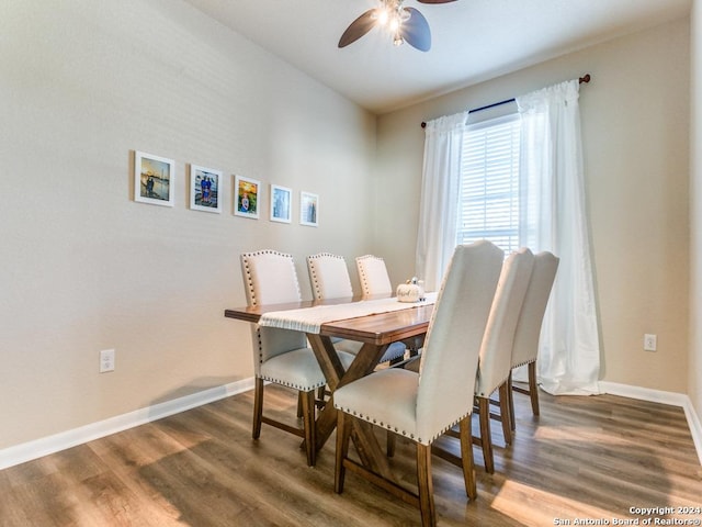 dining room with a ceiling fan, baseboards, and wood finished floors