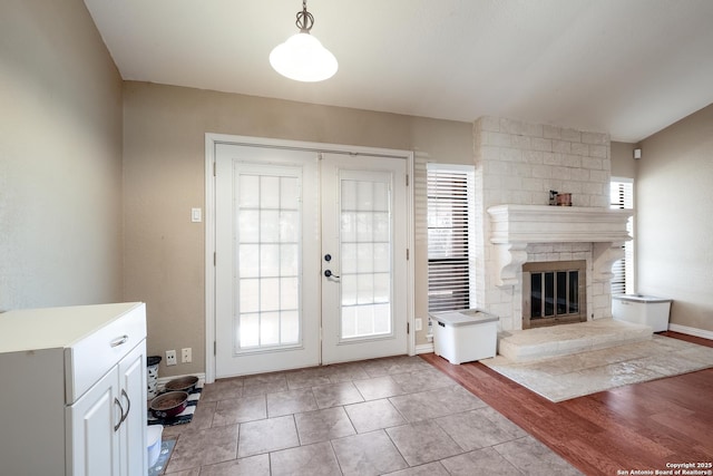 4010 Briarcrest, San Antonio, TX 78247 - foyer entrance with a stone fireplace, french doors, light wood-style floors, and baseboards
