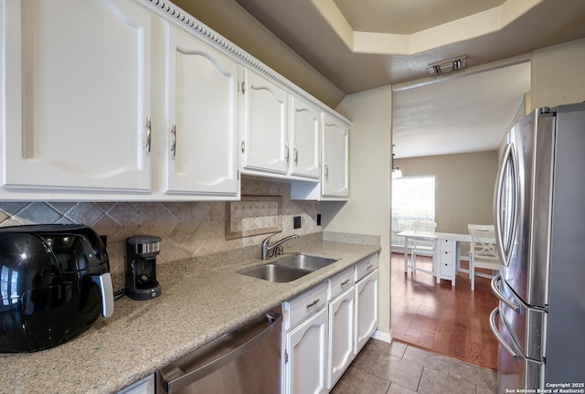 4010 Briarcrest, San Antonio, TX 78247 - kitchen with tile patterned flooring, a sink, white cabinets, appliances with stainless steel finishes, and tasteful backsplash