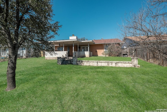 4010 Briarcrest, San Antonio, TX 78247 - rear view of house with a lawn, a chimney, and fence