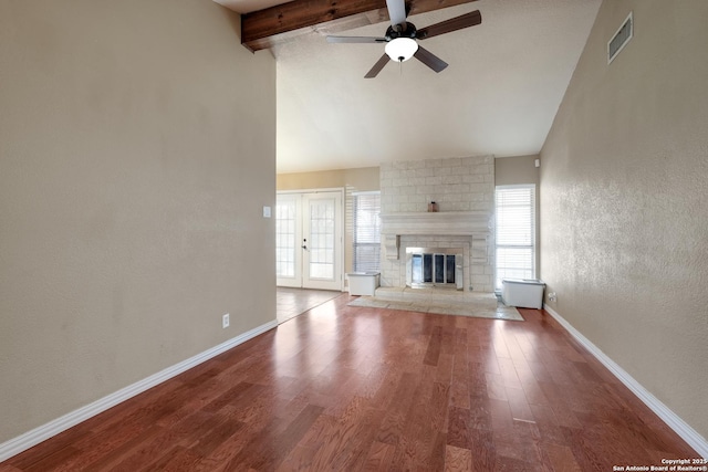 4010 Briarcrest, San Antonio, TX 78247 - unfurnished living room with a fireplace, wood finished floors, visible vents, baseboards, and beam ceiling