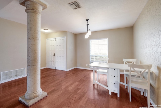 4010 Briarcrest, San Antonio, TX 78247 - dining space with wood finished floors, decorative columns, visible vents, and baseboards