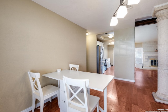 4010 Briarcrest, San Antonio, TX 78247 - dining room featuring a fireplace, decorative columns, baseboards, and wood finished floors