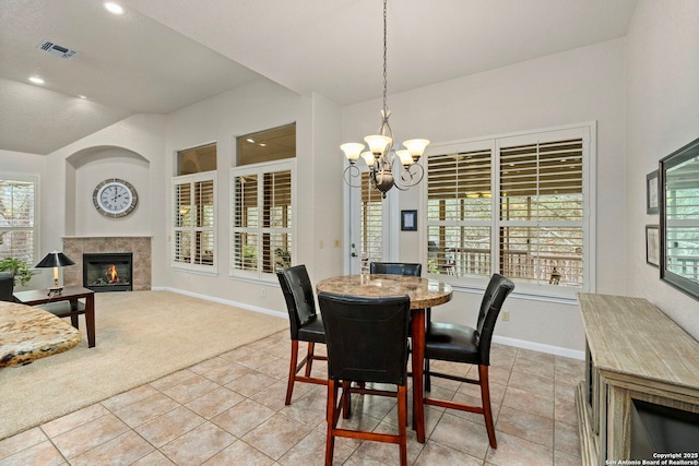 dining space with recessed lighting, light colored carpet, a fireplace, baseboards, and an inviting chandelier