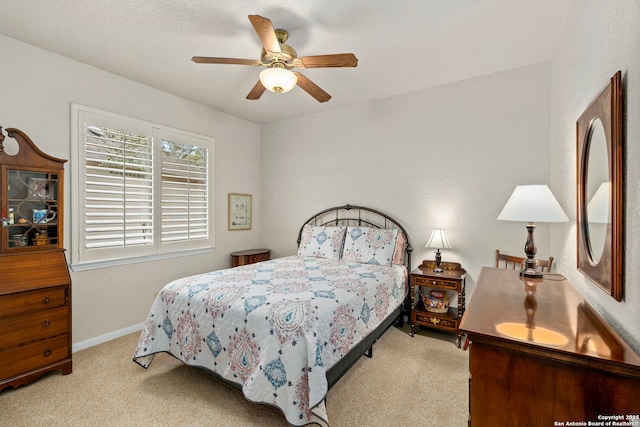 bedroom with carpet, baseboards, and a ceiling fan