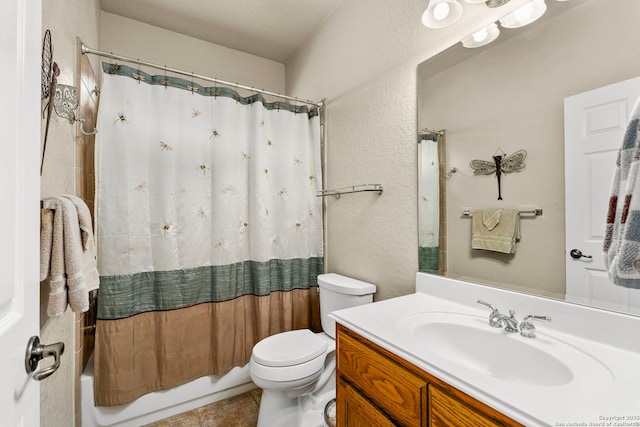 bathroom featuring a textured wall, toilet, vanity, tile patterned floors, and shower / bath combo