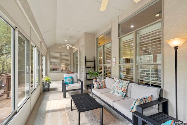 sunroom with lofted ceiling, ceiling fan, and plenty of natural light