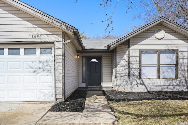 view of exterior entry with an attached garage