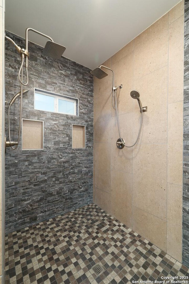 bathroom with a tile shower