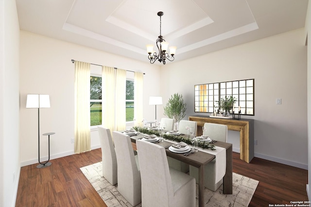 dining area featuring a chandelier, wood finished floors, a raised ceiling, and baseboards