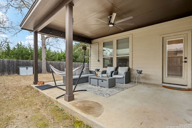 view of patio with ceiling fan, fence, and an outdoor living space