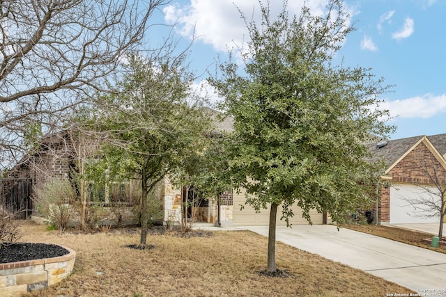 obstructed view of property featuring concrete driveway and an attached garage