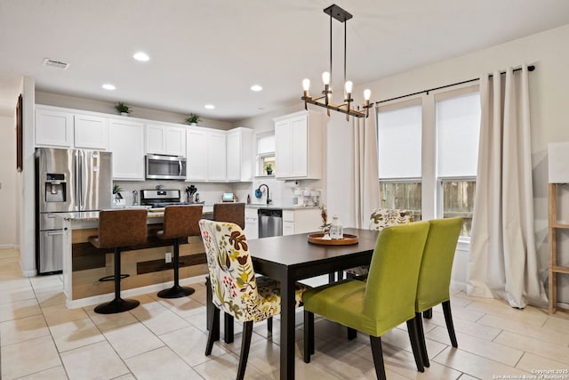 dining area with light tile patterned floors, visible vents, a notable chandelier, and recessed lighting