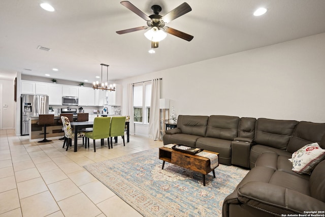 living room with light tile patterned floors, recessed lighting, visible vents, and ceiling fan with notable chandelier