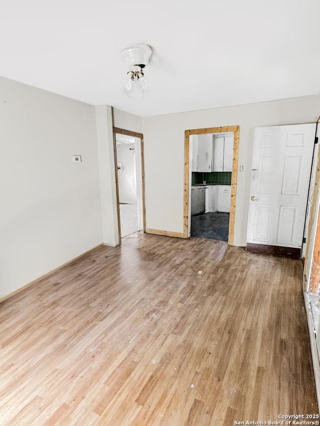 spare room with light wood finished floors and baseboards