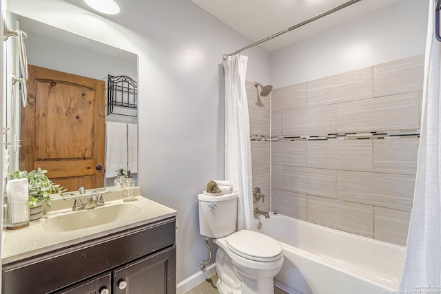 bathroom featuring vanity, shower / bath combination with curtain, toilet, and baseboards