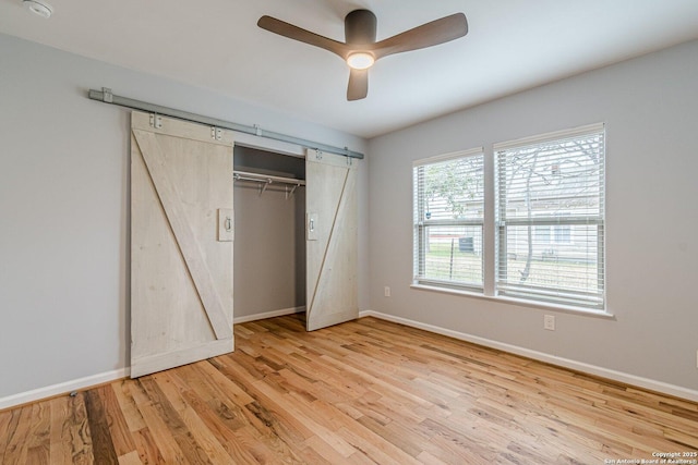 unfurnished bedroom featuring a closet, wood finished floors, and baseboards