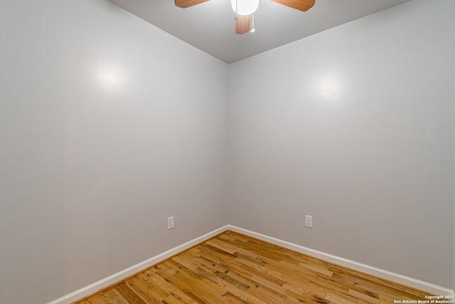 unfurnished room with light wood finished floors, a ceiling fan, and baseboards