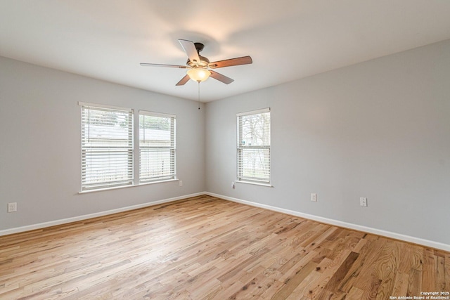 empty room featuring light wood-style flooring, baseboards, and ceiling fan