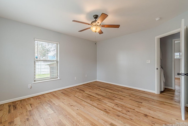 unfurnished room with light wood-type flooring, ceiling fan, and baseboards