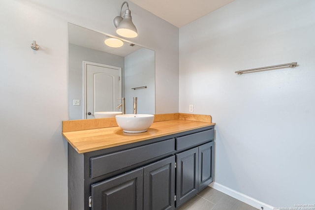 bathroom featuring baseboards and vanity